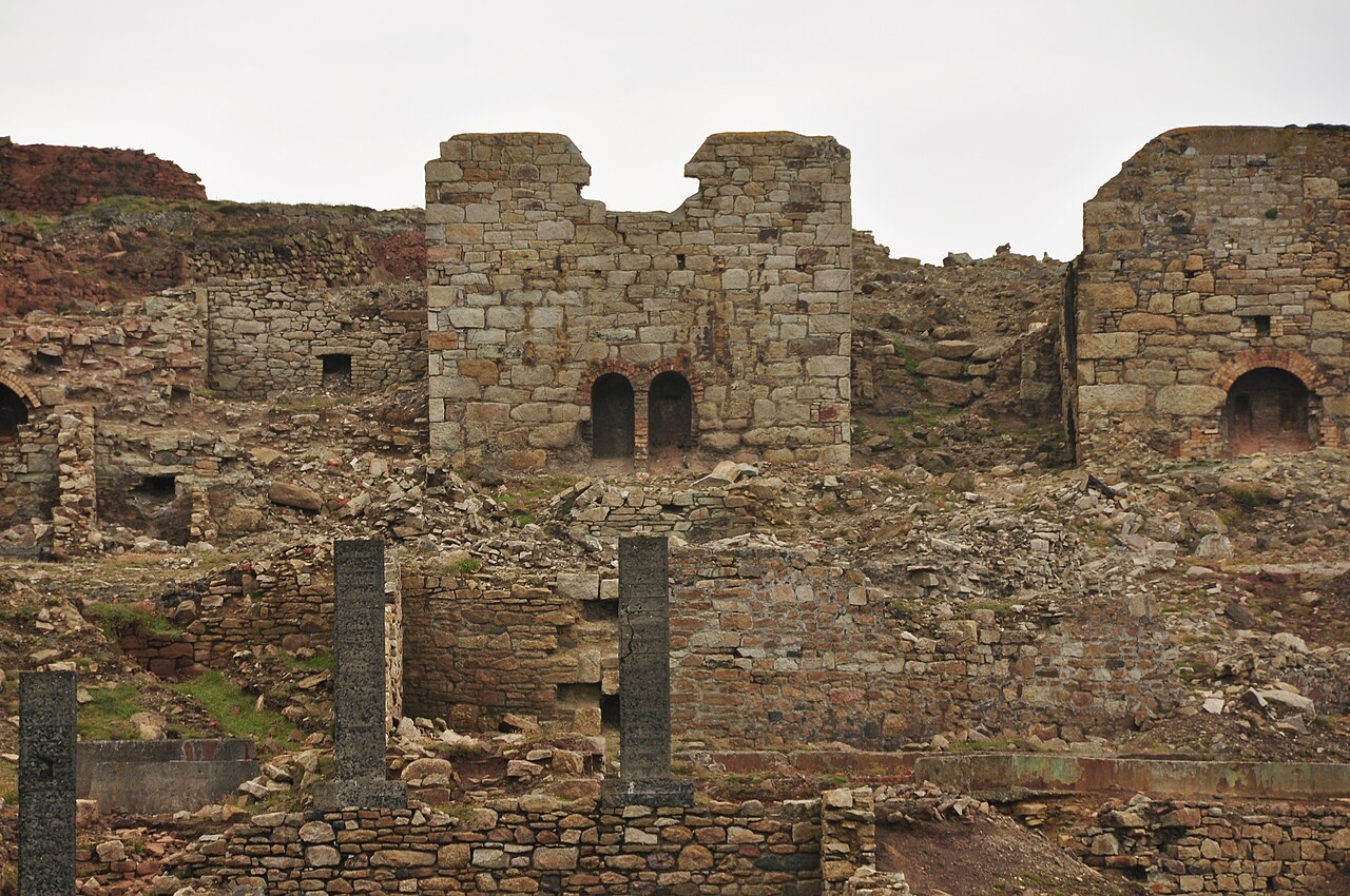 Ruined stone calciner buildings and chimney bases on the Geevor Mine site