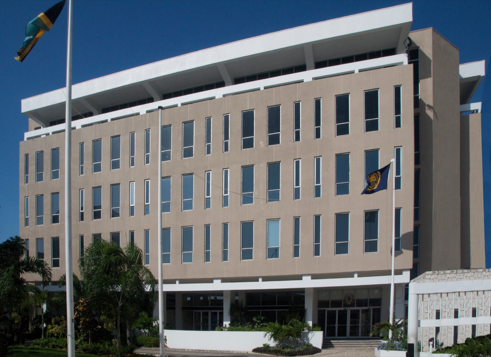 The five-storey beige and white headquarters building of the International Seabed Authority in Kingston, Jamaica, with the Jamaican flag and the ISA flag outside